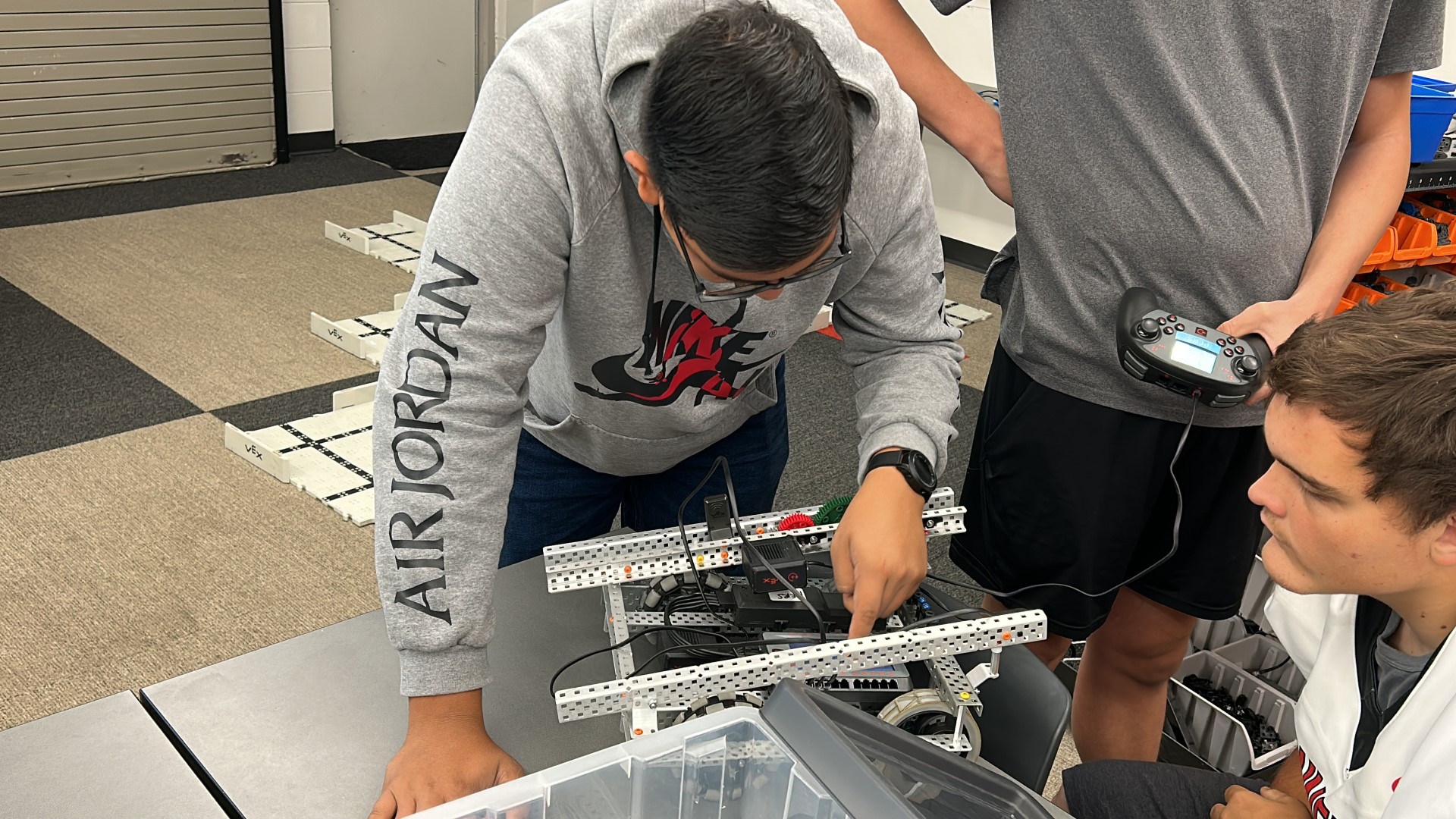 A person working on a machineDescription automatically generated